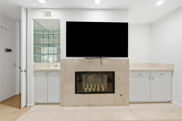 a living room with fireplace and a flat screen tv