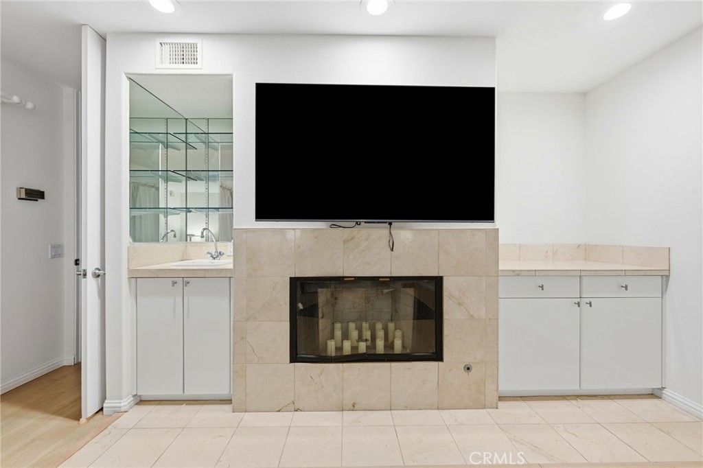 12815 Via Nestore Del Mar, CA 92014 - Photo 20 of 42 a living room with fireplace and a flat screen tv