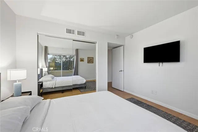 a bedroom with a bed and a flat screen tv