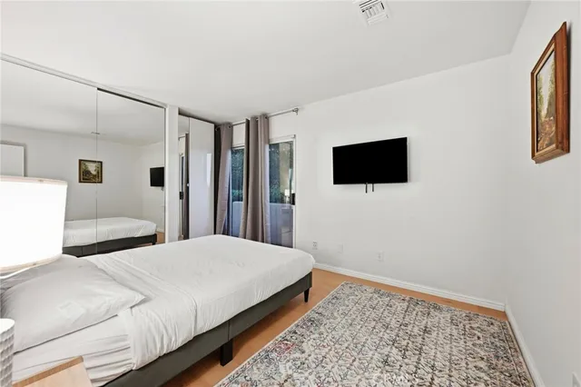 a bedroom with a bed and a flat screen tv