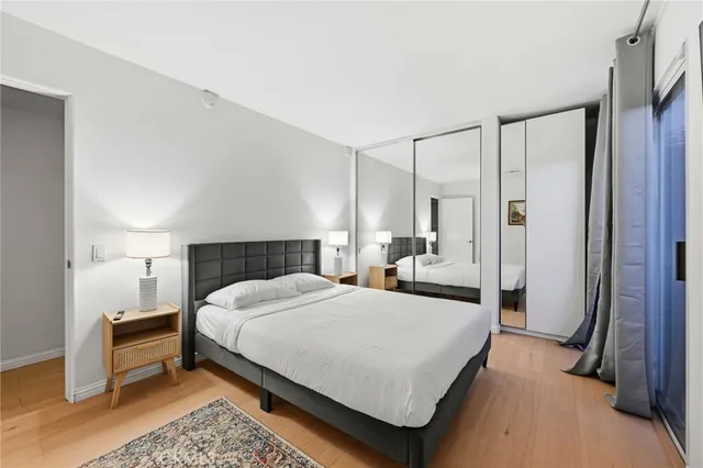 a bedroom with a bed lamp and a dresser