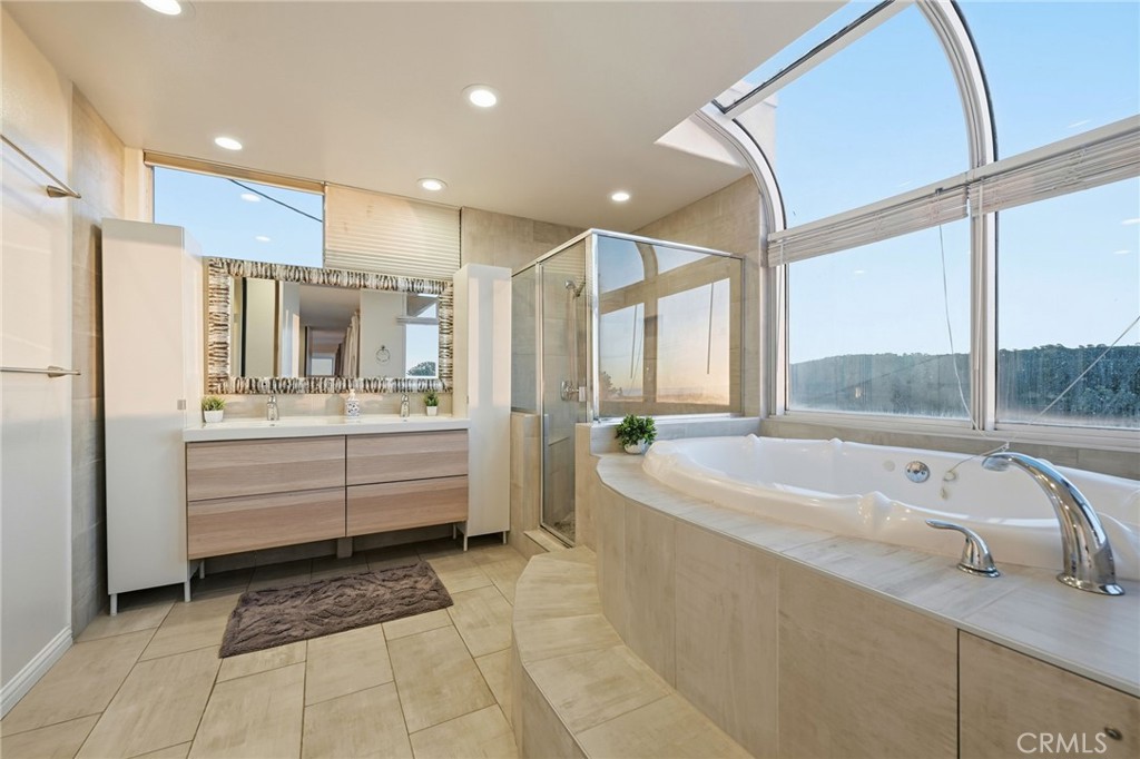 12815 Via Nestore Del Mar, CA 92014 - Photo 31 of 42 a bathroom with a large tub a sink a window and a shower