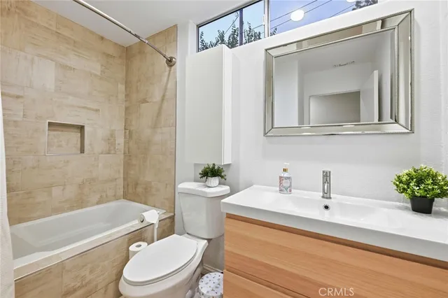 a bathroom with a sink a toilet and a bathtub