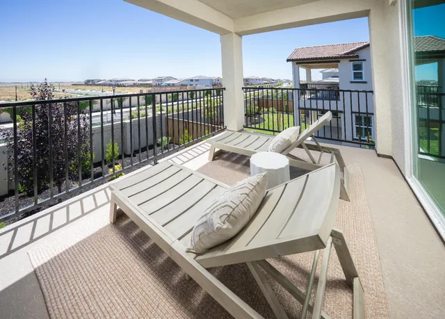 a balcony with a bed