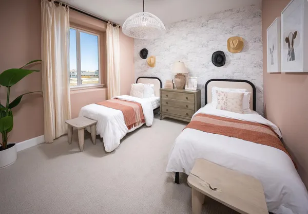 a bedroom with two beds and a large window