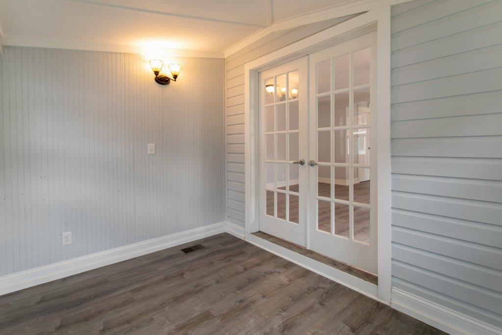 95 Keith Street St. Augustine, FL 32084 - Photo 11 of 49 an empty room with wooden floor and windows