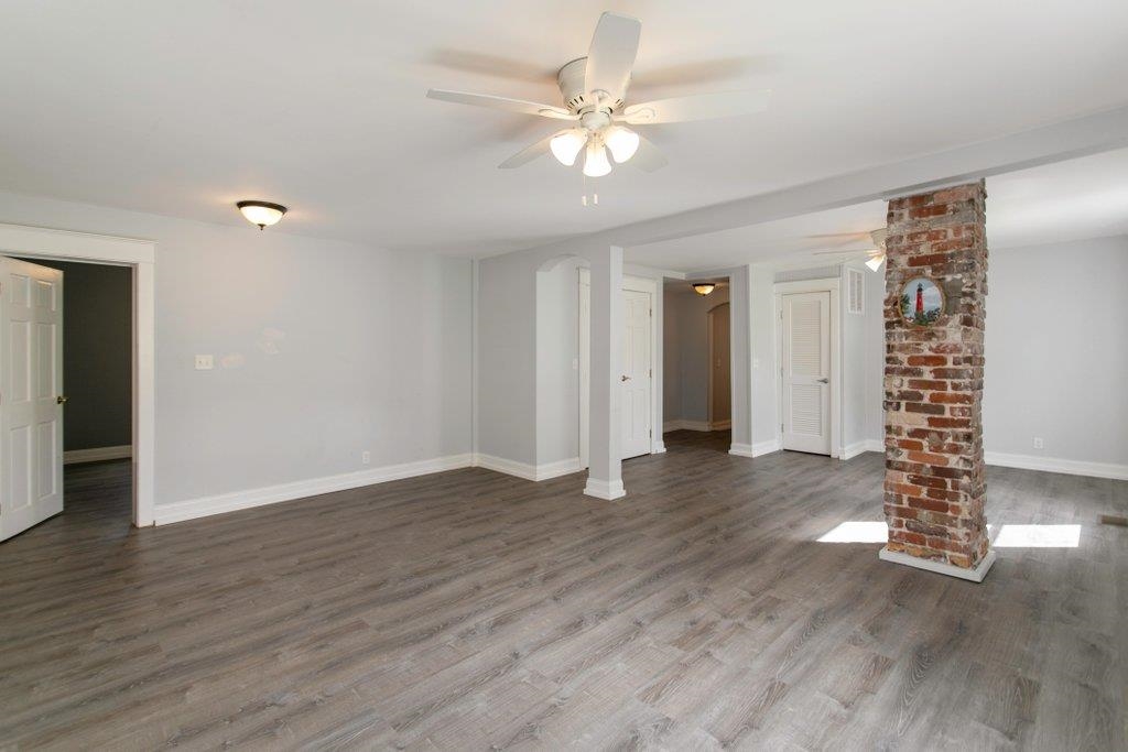 95 Keith Street St. Augustine, FL 32084 - Photo 13 of 49 a view of an empty room with wooden floor and a ceiling fan