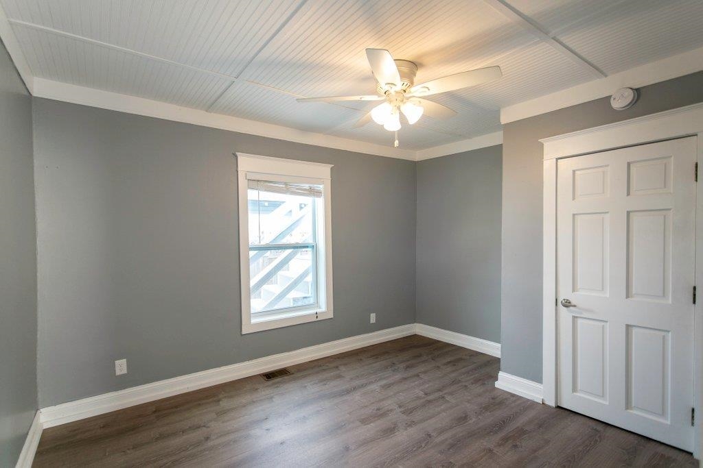 95 Keith Street St. Augustine, FL 32084 - Photo 15 of 49 an empty room with wooden floor fan and windows