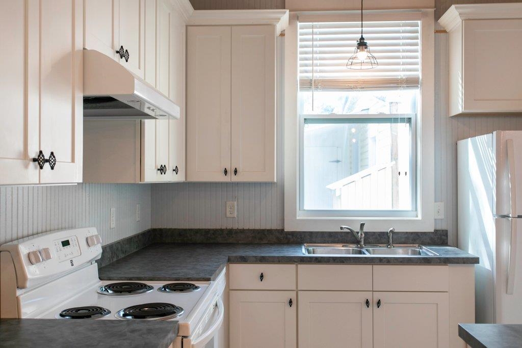 95 Keith Street St. Augustine, FL 32084 - Photo 25 of 49 a kitchen with granite countertop a sink a stove and cabinets
