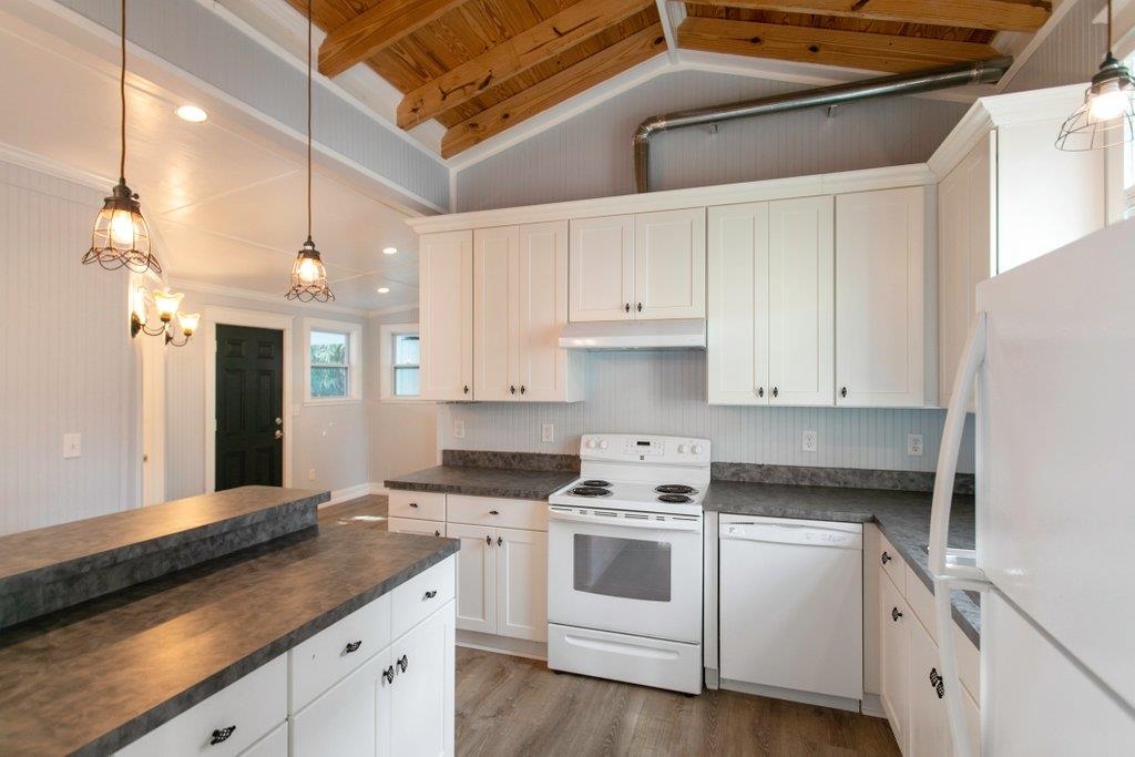 95 Keith Street St. Augustine, FL 32084 - Photo 26 of 49 a kitchen with granite countertop white cabinets and white appliances
