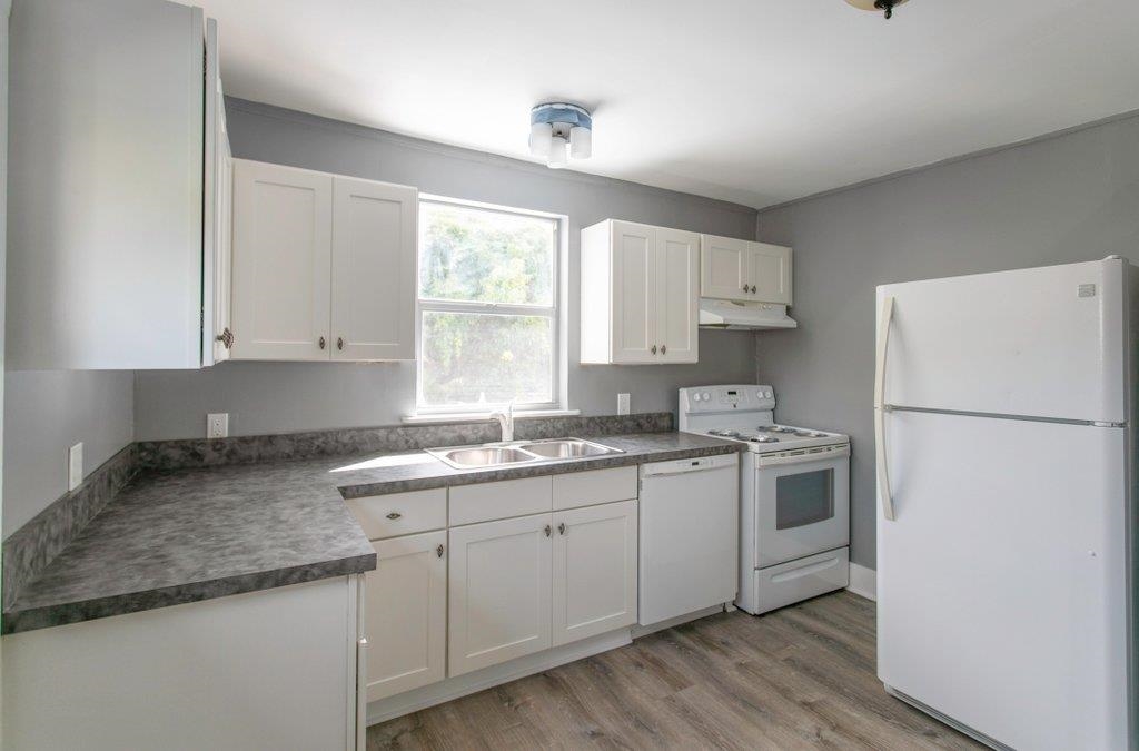 95 Keith Street St. Augustine, FL 32084 - Photo 33 of 49 a kitchen with a sink a refrigerator a window and white cabinets