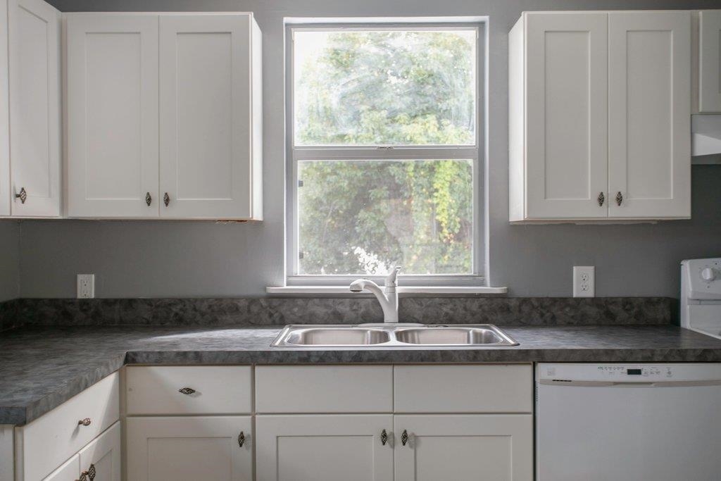 95 Keith Street St. Augustine, FL 32084 - Photo 38 of 49 a kitchen with granite countertop white cabinets and a window
