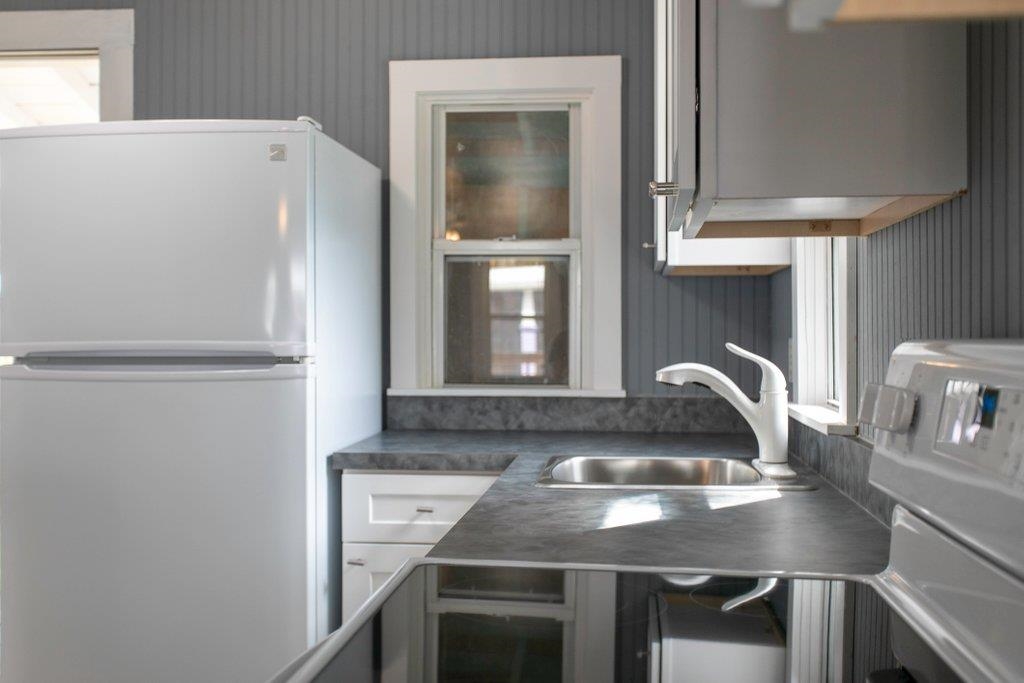 95 Keith Street St. Augustine, FL 32084 - Photo 45 of 49 a kitchen with a refrigerator and a sink