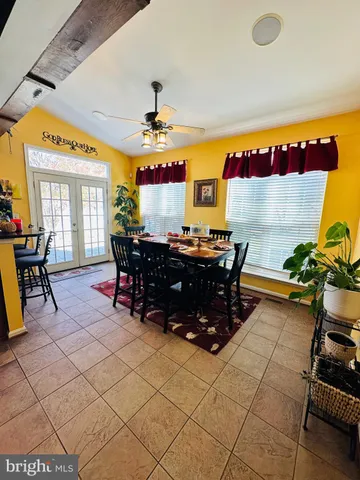 a living room with furniture fireplace and a large window