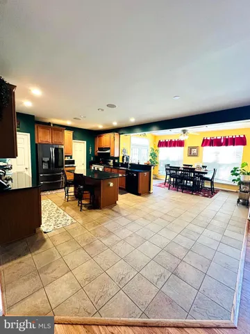 a living room with furniture a chandelier and a fireplace