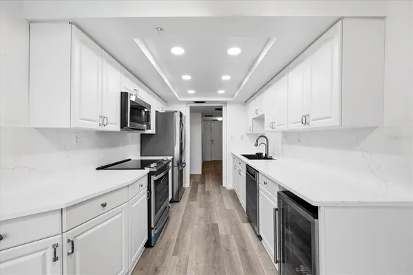a kitchen with stainless steel appliances a stove sink microwave and cabinets