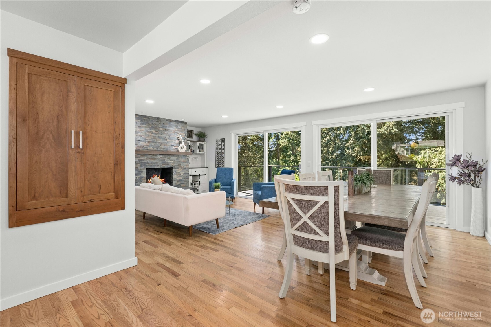 24022 4th Place West Bothell, WA 98021 - Photo 10 of 36 a dining room with furniture wooden floor and a fireplace