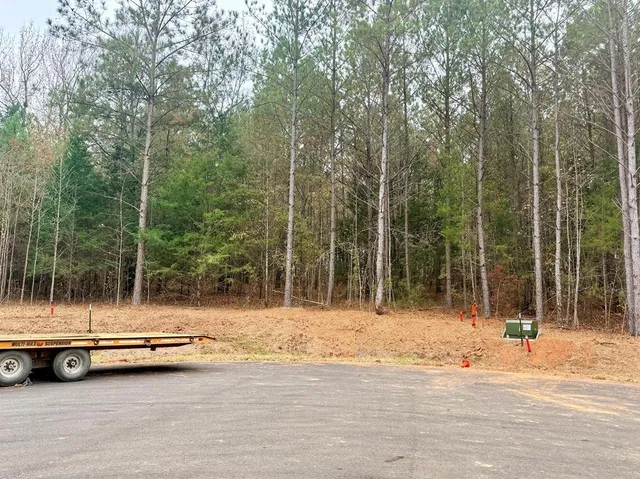 a view of car parked on the side of road with trees
