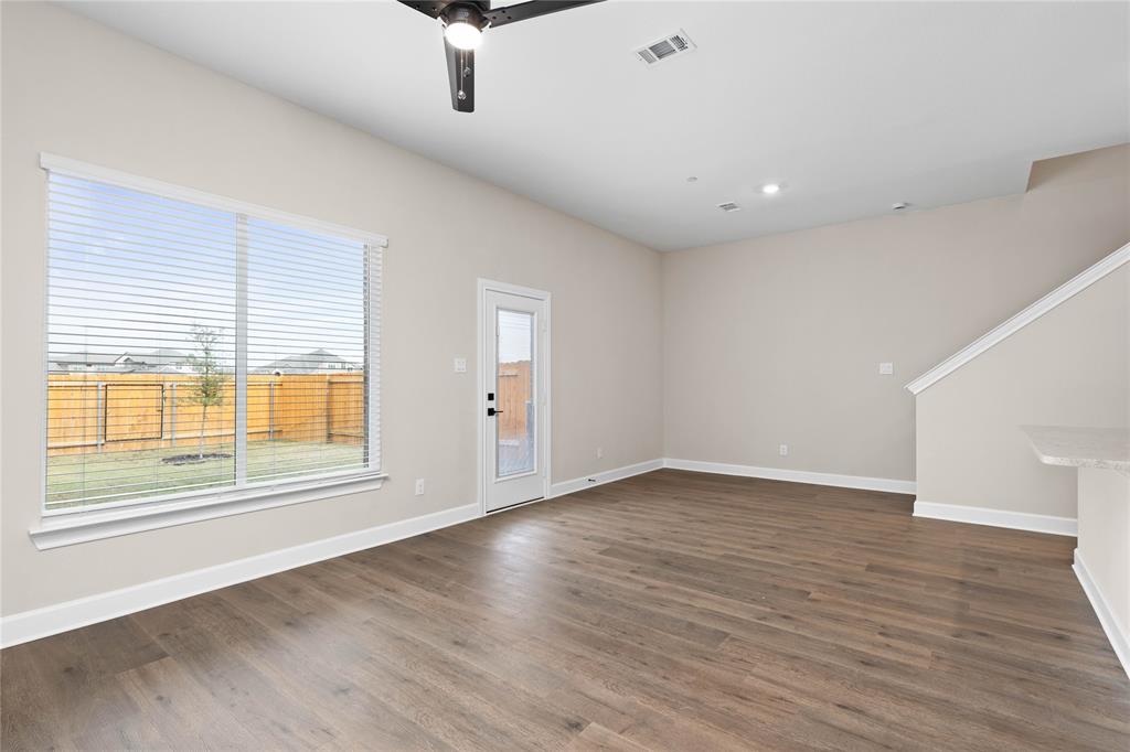720 Carson Lane Pilot Point, TX 76258 - Photo 3 of 8 an empty room with wooden floor and windows