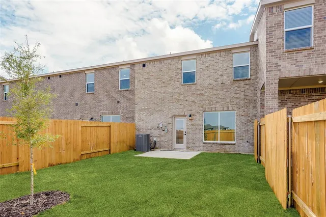 a view of a house with brick walls and a yard