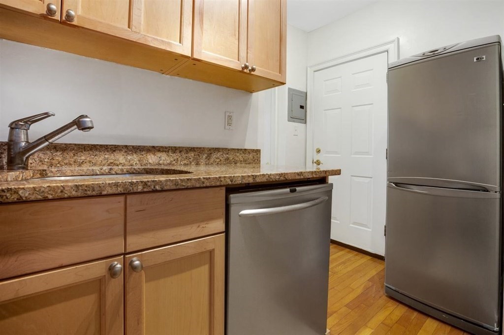 60 Myrtle Street, Unit 1 Boston, MA 02114 - Photo 3 of 14 a kitchen with cabinets and stainless steel appliances