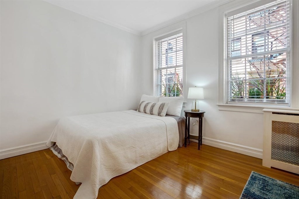 60 Myrtle Street, Unit 1 Boston, MA 02114 - Photo 5 of 14 a bedroom with a bed and a tv