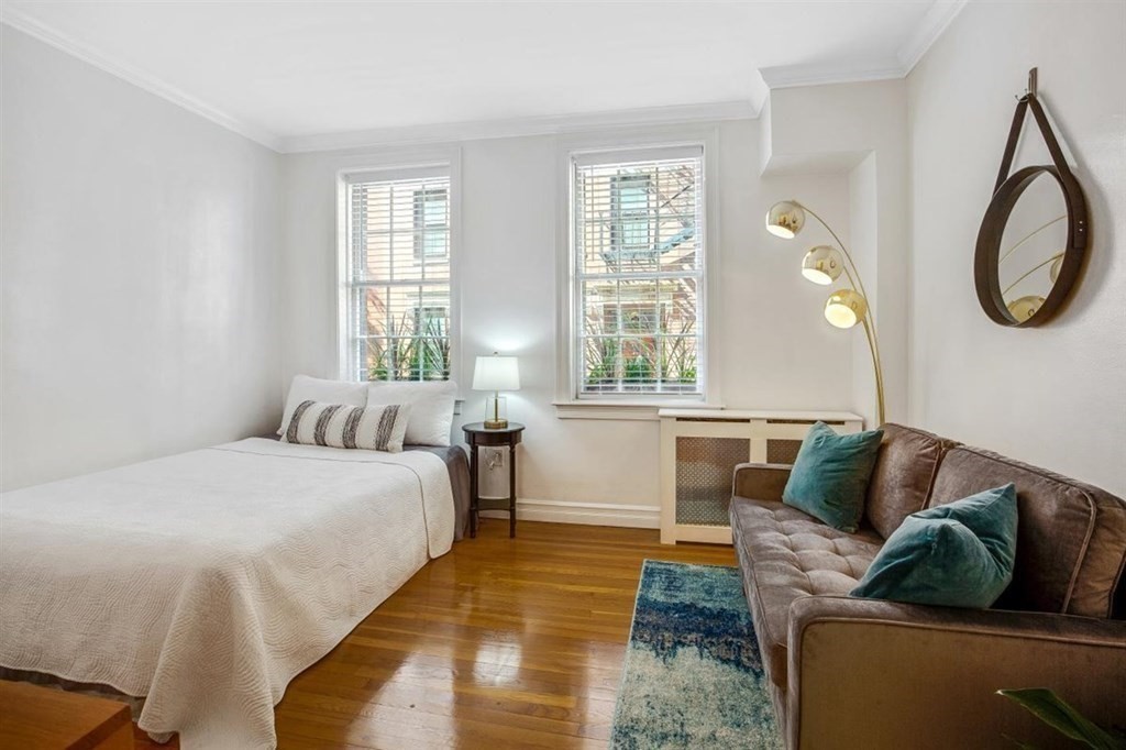 60 Myrtle Street, Unit 1 Boston, MA 02114 - Photo 8 of 14 a bed room with a bed and a couch