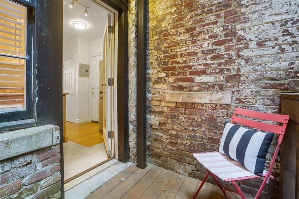 60 Myrtle Street, Unit 1 Boston, MA 02114 - Photo 10 of 14 a balcony with a table and chairs