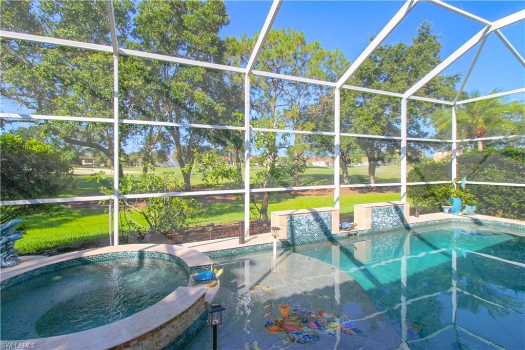 152 Napa Ridge Way Naples, FL 34119 - Photo 11 of 50 a view of a swimming pool with a lounge chair