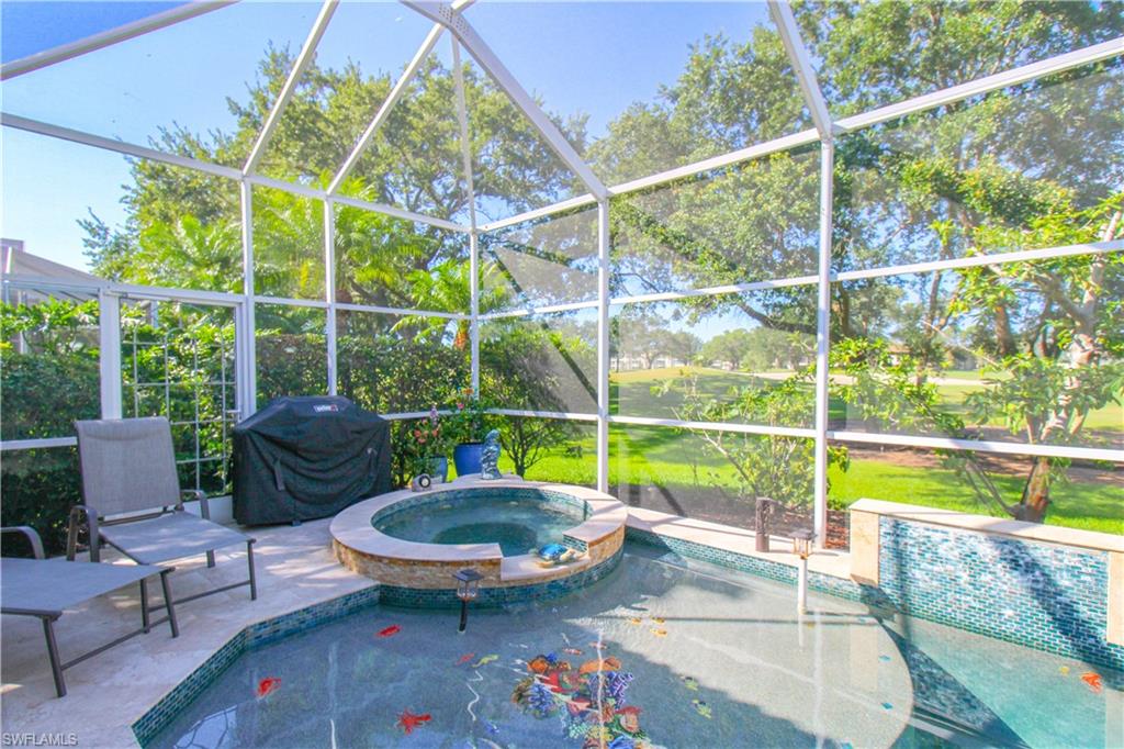 152 Napa Ridge Way Naples, FL 34119 - Photo 13 of 50 a view of a backyard with swimming pool and furniture