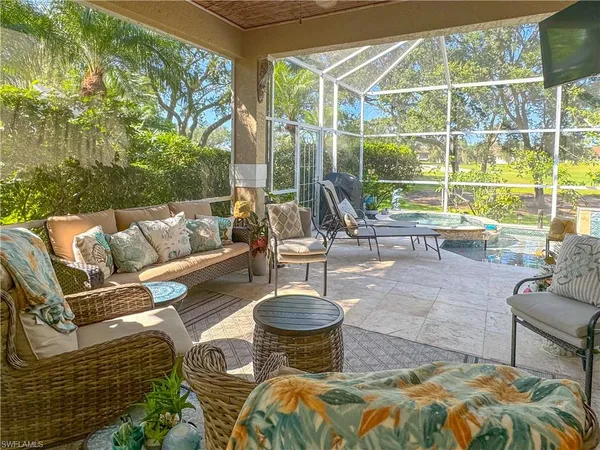 a view of a patio with couches chairs and a potted plant