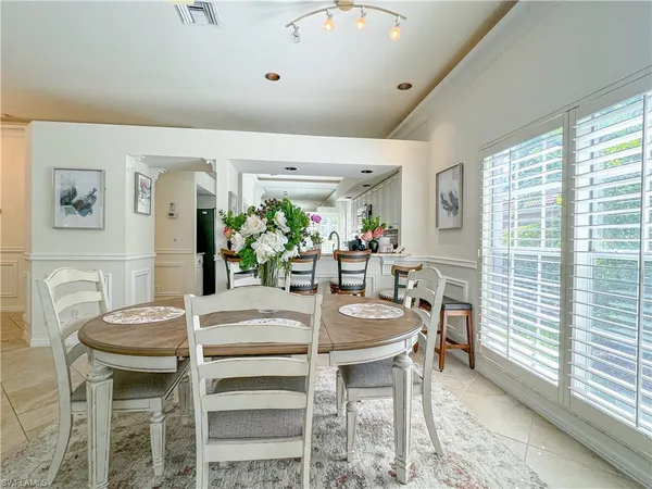 a dining room with furniture and window