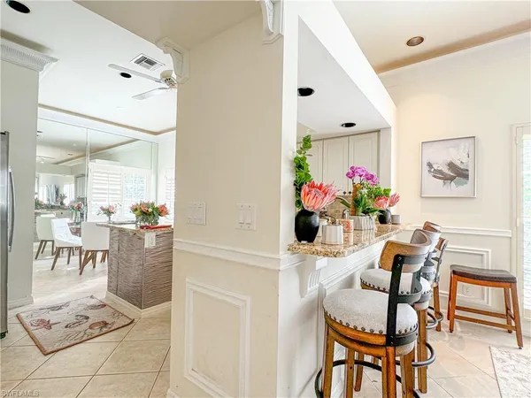 a view of a dining room with furniture and a potted plant
