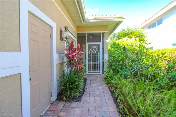 a front view of a house with plants