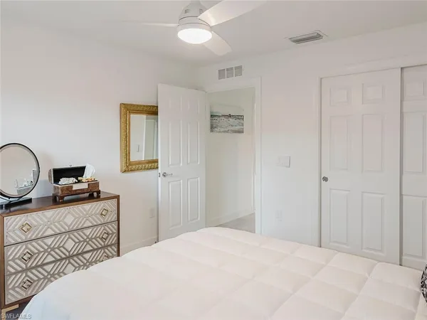 a bedroom with a bed dresser and a window