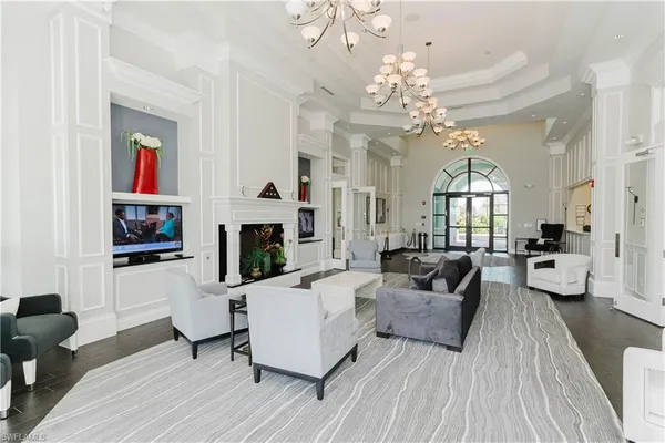 a living room with furniture and a chandelier