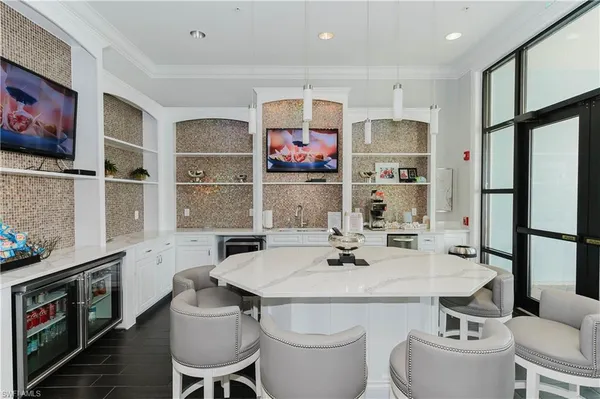 a kitchen with a sink stove and chairs