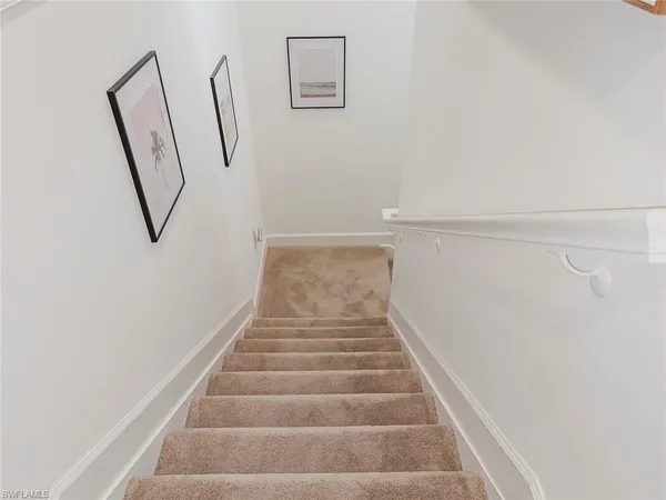 a view of staircase with white walls