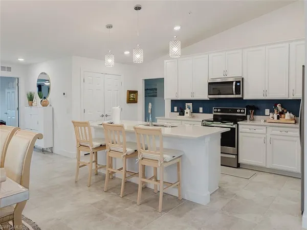 a kitchen with cabinets a sink and appliances