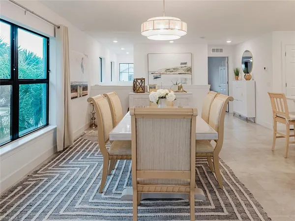 a view of a dining room with furniture wooden floor and chandelier