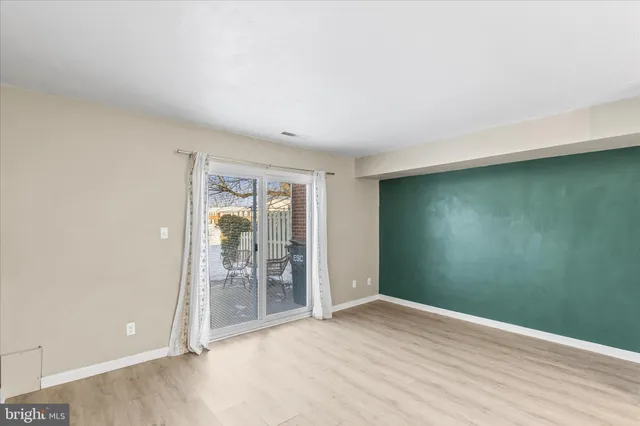 an empty room with sliding door and windows