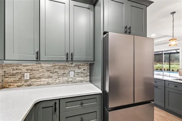 a kitchen with a sink a refrigerator and window