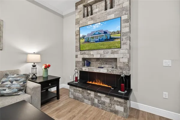 a living room with furniture a ceiling fan and a wooden floor