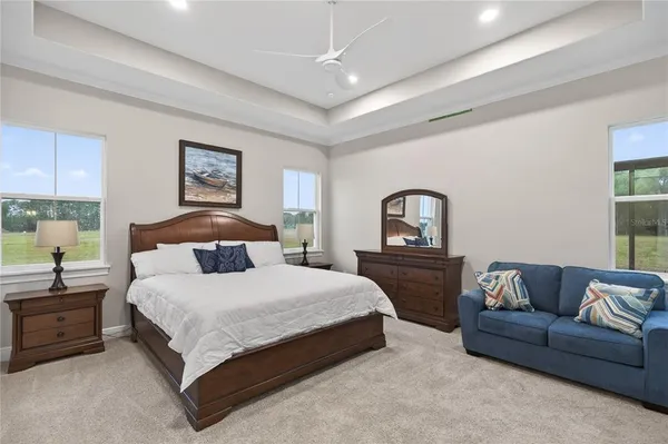 a bedroom with a bed a dresser and a window