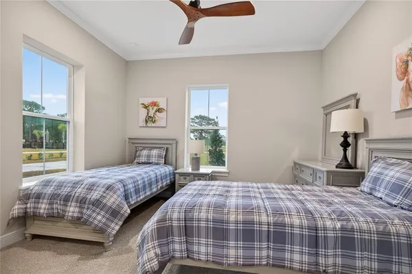 a bedroom with a bed and painting on the wall