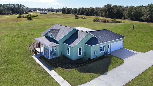 a view of a house with a yard and a swimming pool