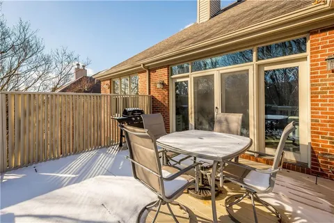 a view of a patio with a table and chairs