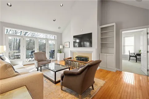 a living room with fireplace furniture and a flat screen tv