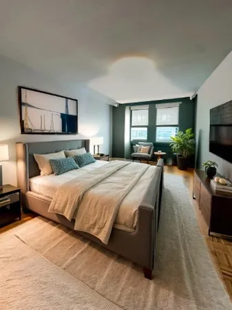 a bedroom with a bed and a flat screen tv