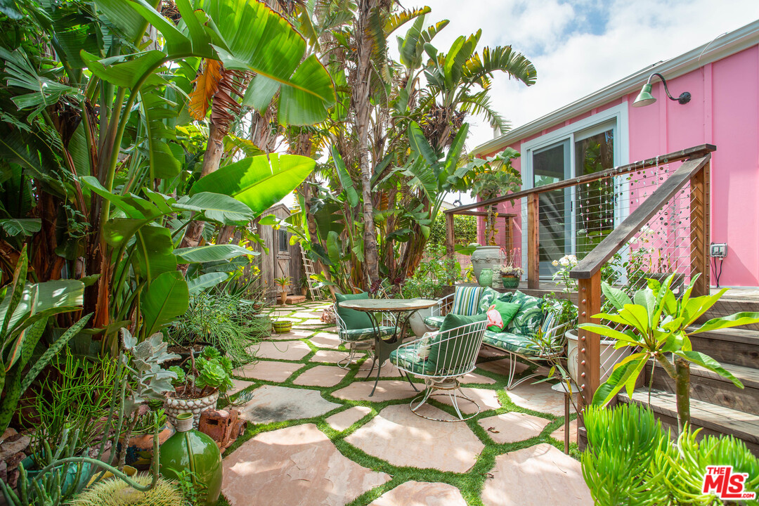 a view of a chairs in a backyard of a house